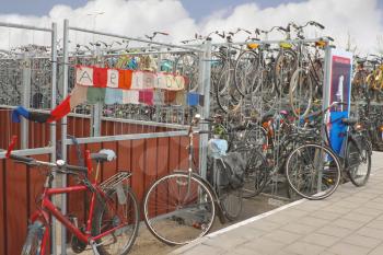 DELFT, THE NETHERLANDS - APRIL 7, 2012 : Plenty bicycles at parking lot  in Delft, Netherlands