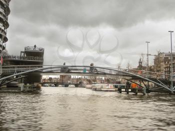 Openwork metal bridge over a canal in  Amsterdam. Netherlands