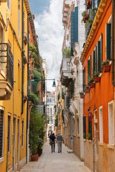 VENICE, ITALY - MAY 06, 2014: People on a narrow street in Venice, Italy