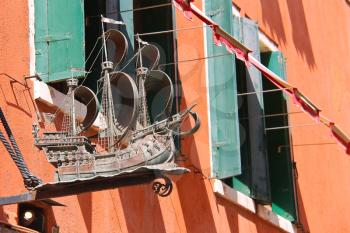 VENICE, ITALY - MAY 06, 2014: Model beautiful sailboat on a facade the house in Venice, Italy