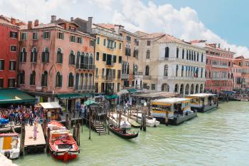 VENICE, ITALY - MAY 06, 2014: Tourists on quay of the Grand Canal  in sunny spring day,Venice, Italy