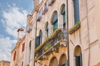 Picturesque Italian house with flowers on the balconies 