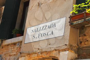 VENICE, ITALY - MAY 06, 2014: Street name on a wall of Italian house in Venice, Italy