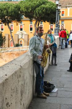ROME, ITALY - MAY 03, 2014: Street musician playing the saxophone in Rome, Italy 