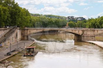 ROME, ITALY - MAY 03, 2014: People on the promenade and bridge across the Tiber in Rome, Italy
