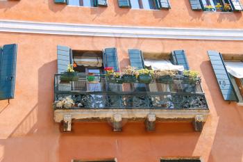 Picturesque balcony with flowers in an old Italian house 