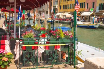 VENICE, ITALY - MAY 06, 2014: Tourists rest in an outdoor cafe,Venice, Italy