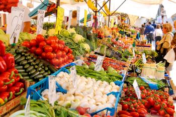 VENICE, ITALY - MAY 06, 2014: People near a counter with vegetables on a market in Venice, Italy