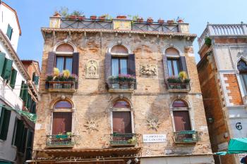 VENICE, ITALY - MAY 06, 2014: Facades of the houses on the street in Venice, Italy