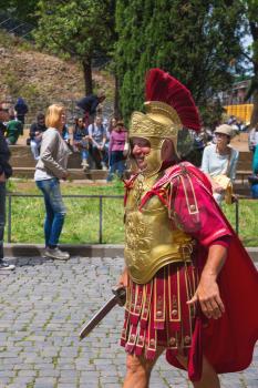 ROME, ITALY - MAY 03, 2014: Actor depicting a Roman legionary for tourists near the Colosseum. Rome, Italy
