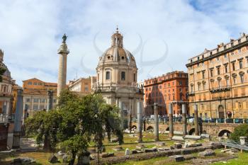 ROME, ITALY - MAY 04, 2014: Ruins of the Forum of Trajan on background of the church Holy Name of Mary and of Trajan's Column in Rome, Italy