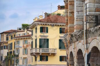VERONA, ITALY - MAY 7, 2014: Urban buildings near the Arena of Verona - the place of annual festival operas in Verona, Italy 