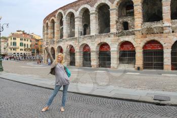 VERONA, ITALY - MAY 7, 2014: Attractive girl near the Arena of Verona - the place of annual festival operas in Verona, Italy 