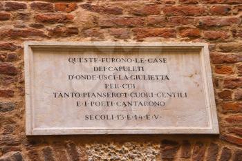 VERONA, ITALY - MAY 7, 2014: Memorial plaque on wall of the house Juliet in Verona, Italy