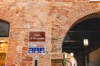 VERONA, ITALY - MAY 7, 2014: Warning plate near the house Juliet in Verona, Italy