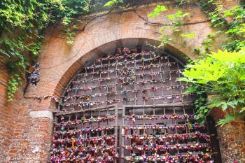VERONA, ITALY - MAY 7, 2014: Many love locks on the gates of the Juliet house in Verona, Italy