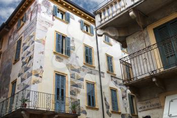 The picturesque house with murals on the street via Arche Scaligere in Verona, Italy