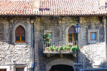 Picturesque Italian house with flowers on the balconies