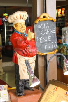 SAN MARINO. SAN MARINO REPUBLIC - AUGUST 08, 2014: Mannequin welcoming cook in an restaurant in San Marino. The Republic of San Marino