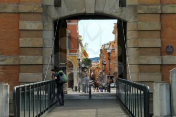 Bologna, Italy - August 18, 2014: People near the ancient gate Galliera (Porta Galliera) in the city of Bologna.