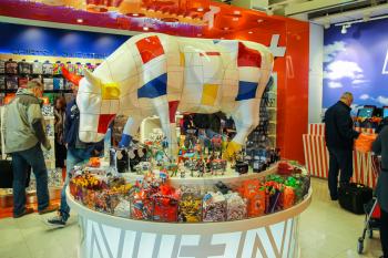 Amsterdam Schiphol, Netherlands - April 18, 2015: Passengers are shopping in the gift shop at the airport Amsterdam Schiphol, Netherlands