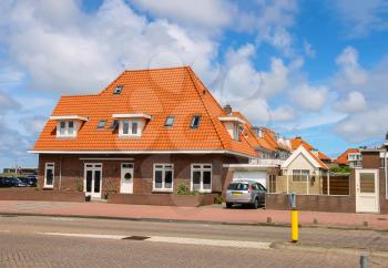 An auto is standing near the residential house in the center of town. Zandvoort aan Zee is a main sea resort and touristic center with a long sandy beach bordered by coastal dunes.