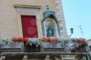 Facade of Rimini City Hall with statue on Cavour square in Rimini, Italy
