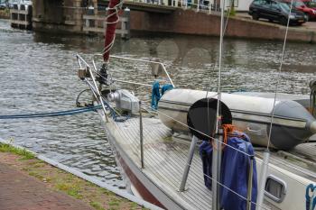 Anchored yacht in Spaarne river channel of Haarlem, the Netherlands