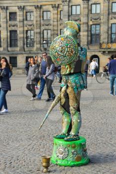 Amsterdam, the Netherlands -October 03, 2015: Human statue street performer on Dam Square in historic city centre