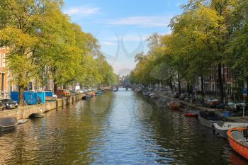 Amsterdam, the Netherlands -October 03, 2015: Small boats on the canal in historic city centre