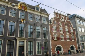 Amsterdam, the Netherlands -October 03, 2015: Old style buildings with shutters and coat of arms in historic city centre