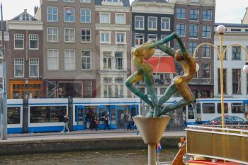 Amsterdam, the Netherlands - October 03, 2015: Sculpture of the young man and women in historic city centre