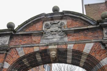Ancient arch with heraldic sign on it in historic centre of Utrecht, the Netherlands