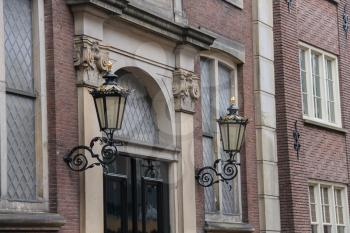 Vintage style lanterns on facade of old dutch building in Utrecht