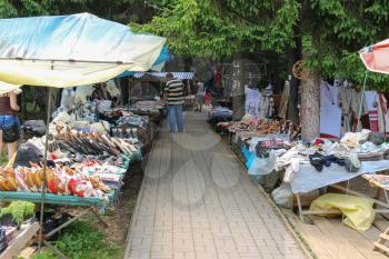 Schodnica, Ukraine - June 30, 2014: People walking between trade stalls with ukrainian souvenirs
