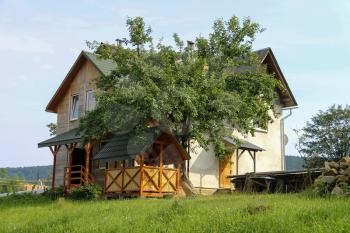 Modern cottage with wooden porch and veranda. Carpathians, Ukraine