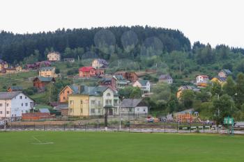 Schodnica, Ukraine - June 30, 2014: Panorama of Schodnica on slope of forested mountains. Carpathians, Ukraine