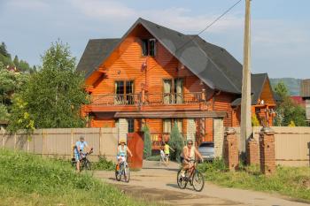 Schodnica, Ukraine - June 30, 2014: People riding bicycles. Carpathians