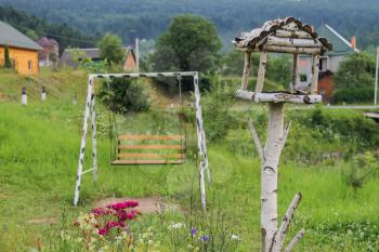 Wooden swing and birdhouse in Carpathians, Ukraine