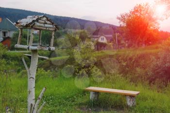 Wooden bench and birdhouse in Carpathians, Ukraine