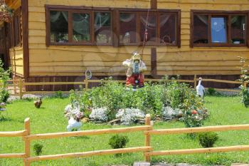 Schodnica, Ukraine - July 08, 2014: Folk style decorative figures before rural house. Carpathians, Ukraine