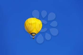 Yellow balloon in blue sky