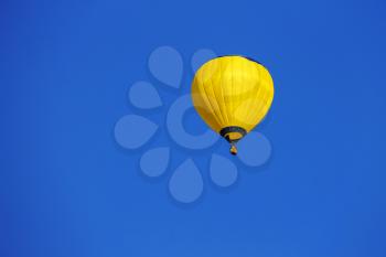Yellow balloon in blue sky