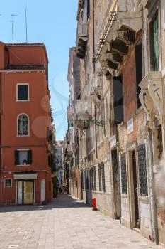 Venice, Italy - August 13, 2016: Tourists walking in street of city centre