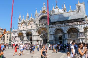 Venice, Italy - August 13, 2016: Tourists on famous St. Mark's Square. View of San Marco Basilica