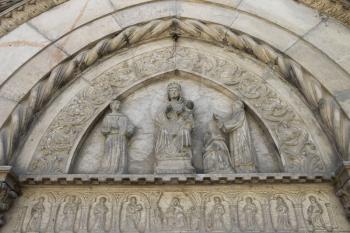 Part of religious sculptural composition above entrance to chapel in medieval castle. Grazzano Visconti, Italy
