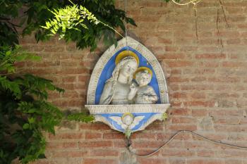 Grazzano Visconti, Italy - August 07, 2016: Wall bas-relief of the Madonna and Child