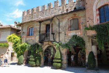 Grazzano Visconti, Italy - August 07, 2016: Tourists in the courtyard of ancient castle