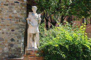 Marble statue of St. Cosmas at the entrance to the parish of Cosmas and Domian, Grazzano Visconti, Italy