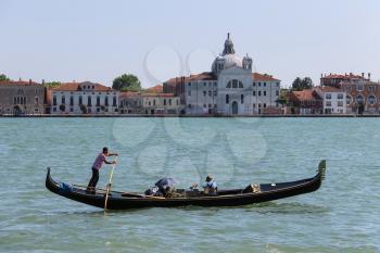 Venice, Italy - August 13, 2016: Gondola with tourists in Grand Canal